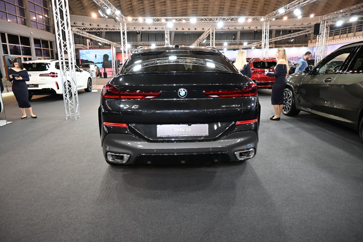 Rear view of BMW SUV with sleek tail lights and dual exhausts
