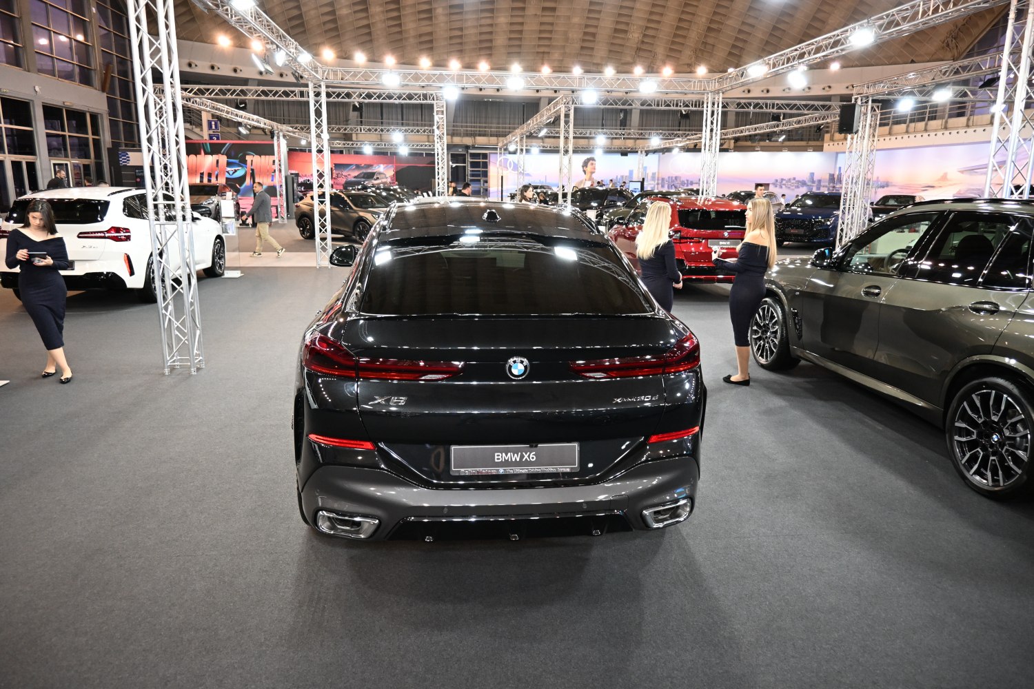 Rear view of a black luxury SUV with distinctive tail lights and dual exhausts