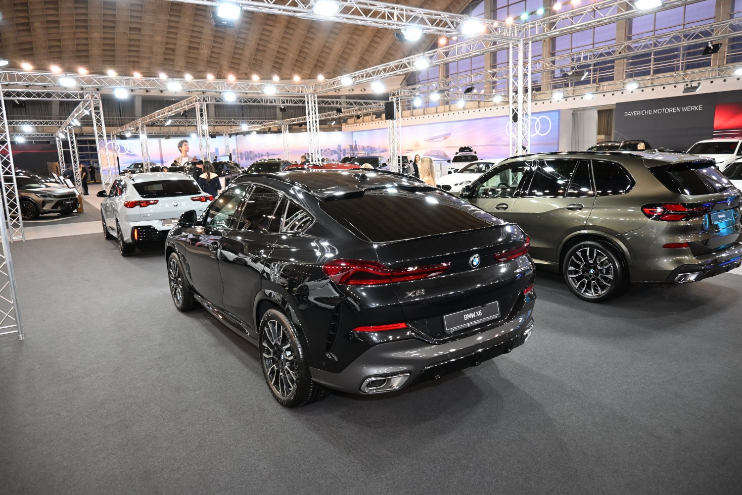 Rear view of a black luxury SUV showing tail lights and sport wheels