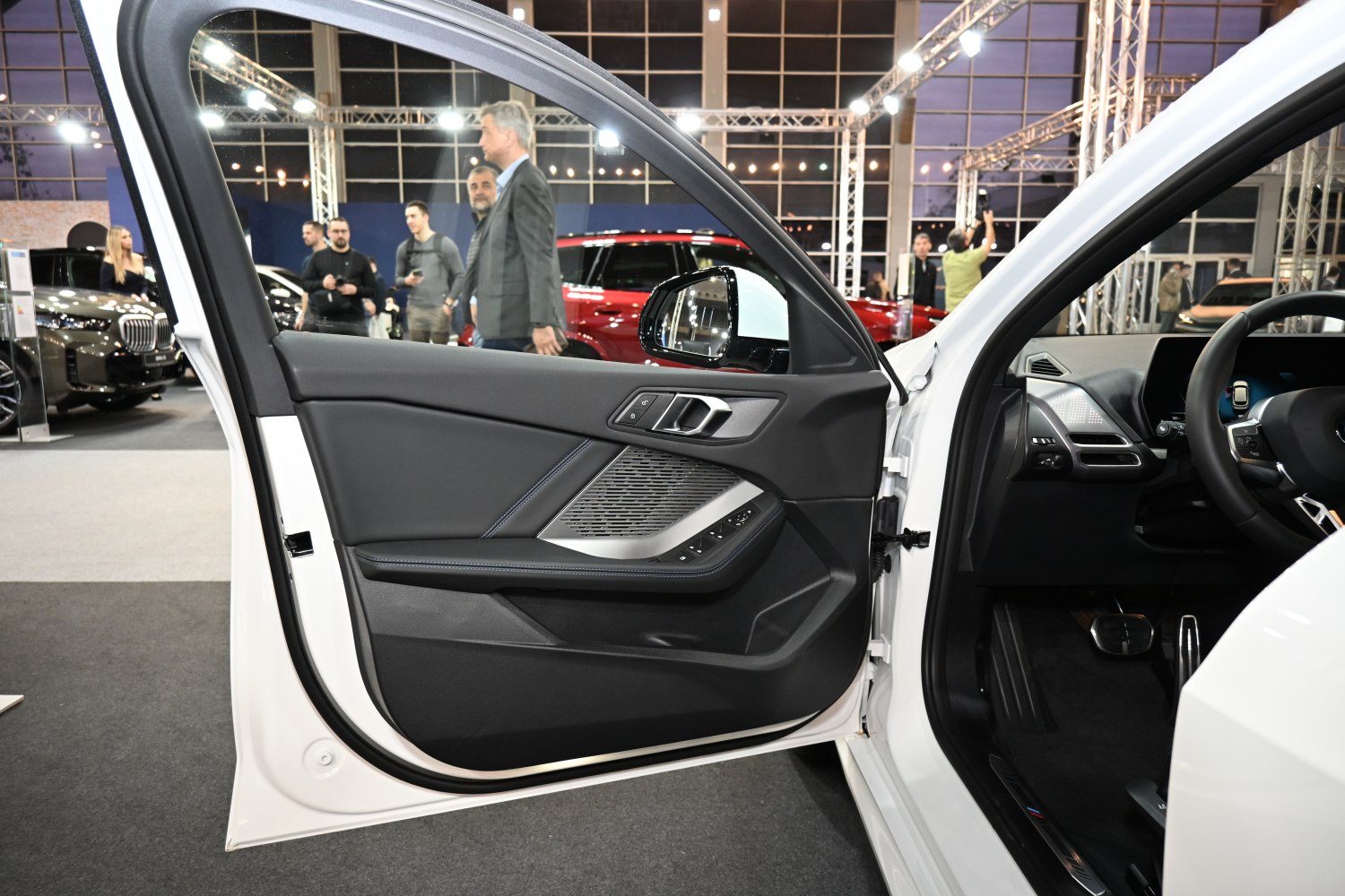 Modern car interior door panel with controls and premium materials