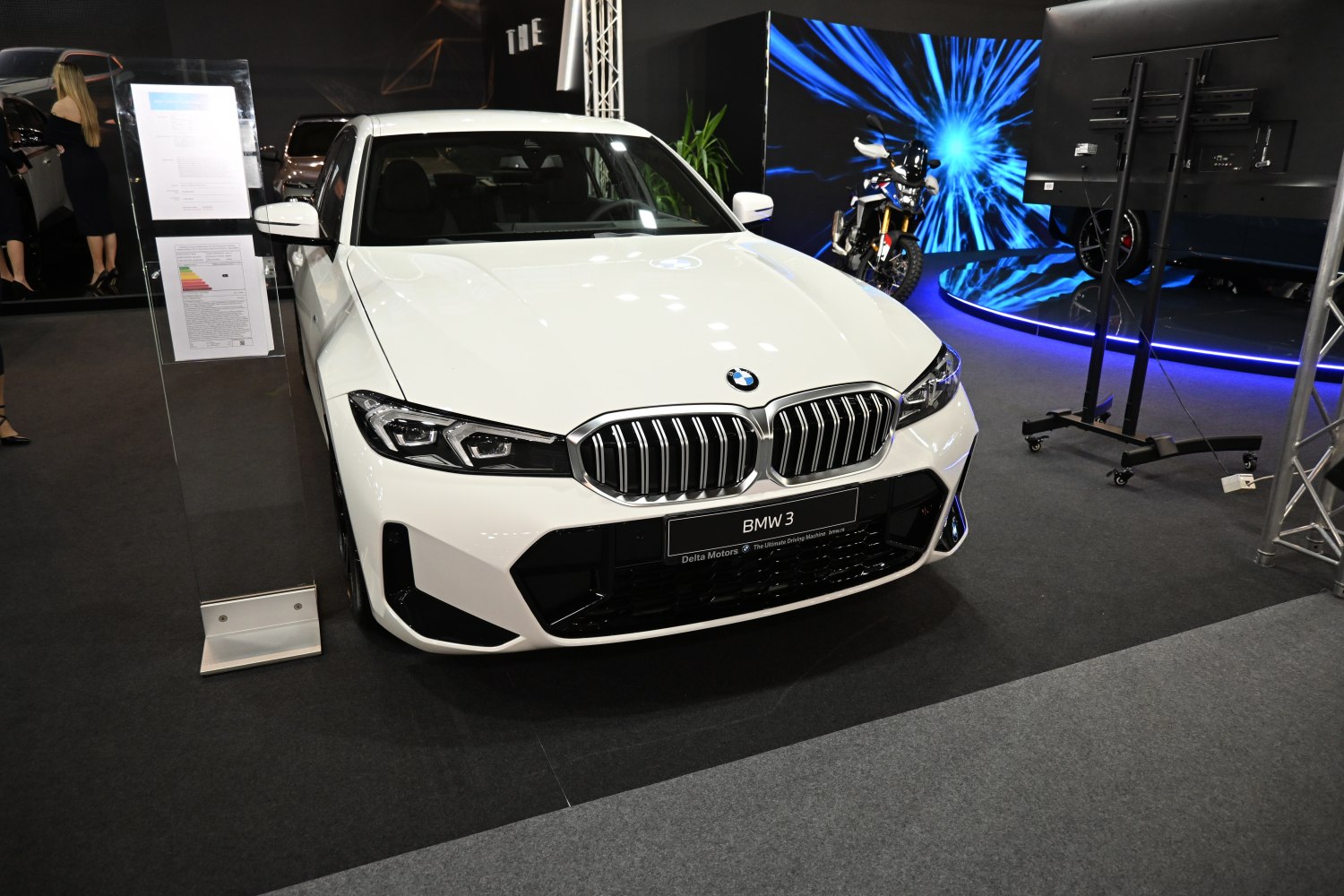 Distinctive kidney grille and LED headlights on a white sedan front