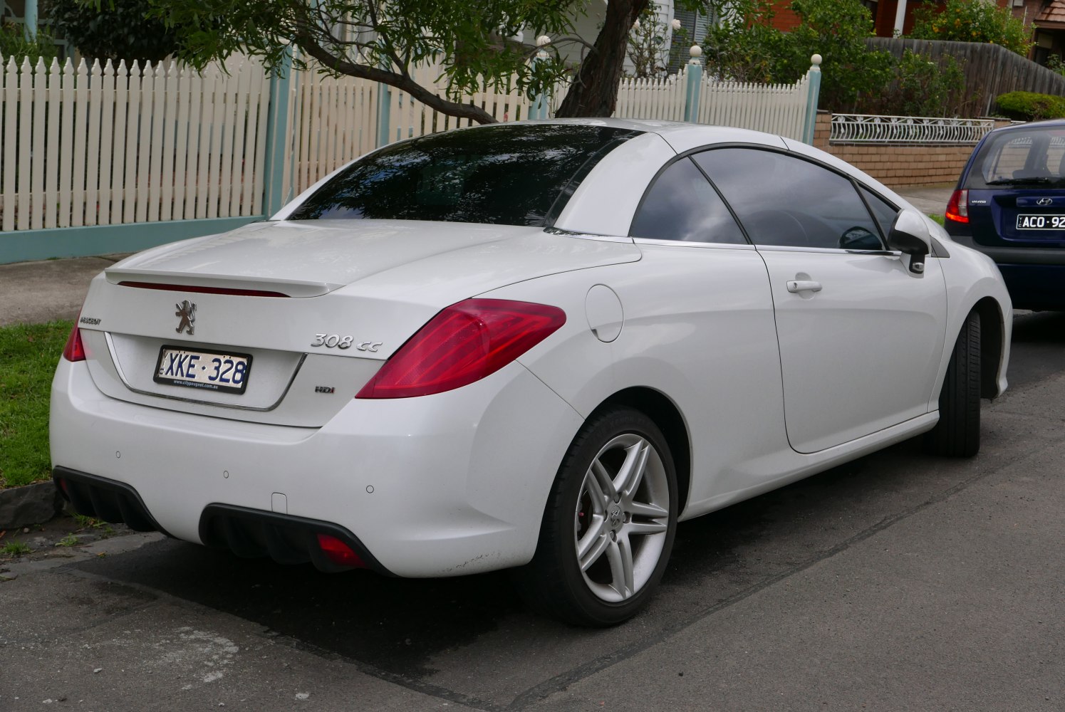 Rear side view of white convertible with alloy wheels