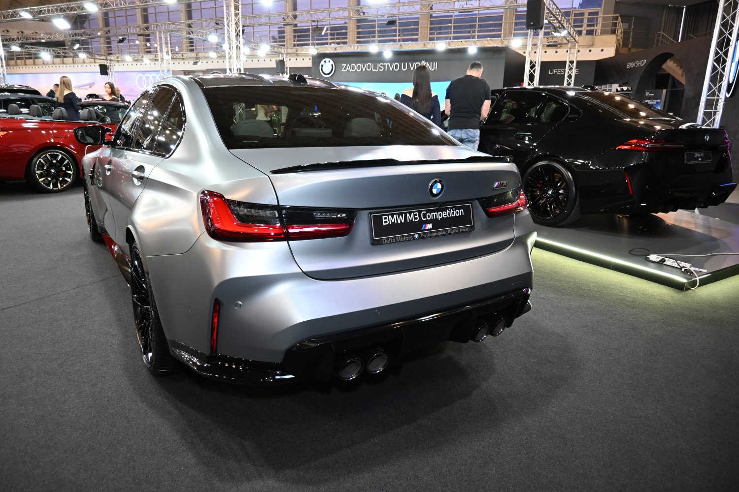 Rear view of a sport sedan with quad exhaust and LED taillights