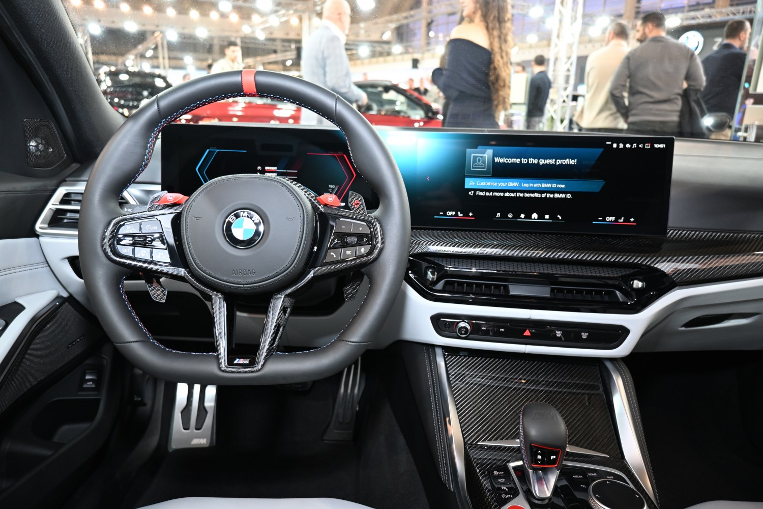 Sporty steering wheel and digital dashboard with carbon fiber trim