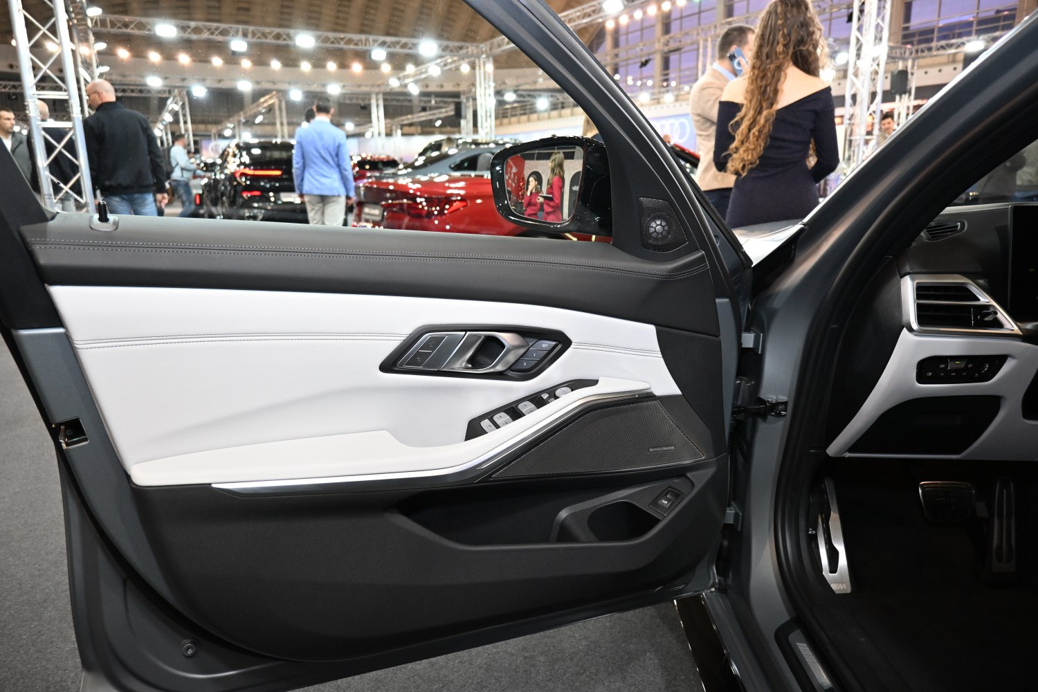 Interior door panel with controls and speaker in modern vehicle