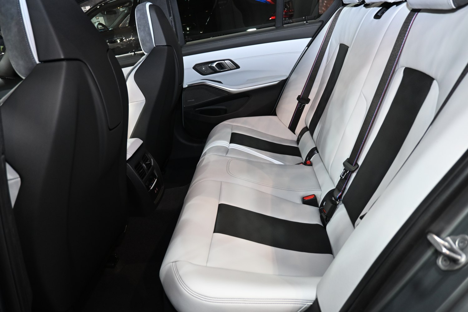 Rear leather seats with distinct black and white color pattern.