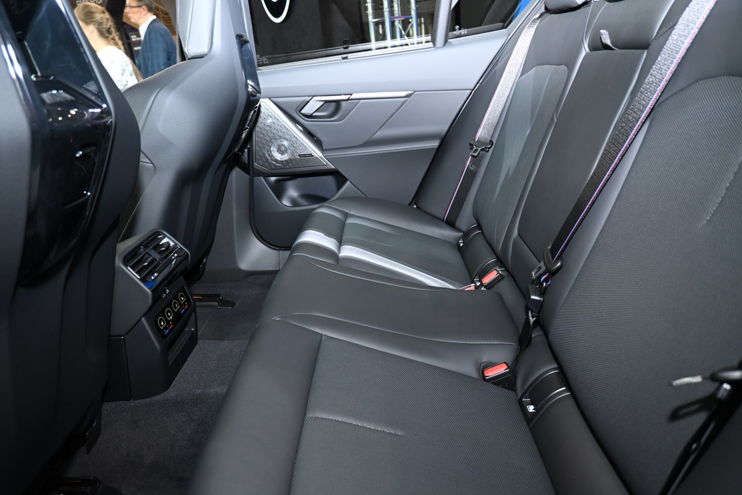 Rear seat interior with black leather upholstery and rear climate controls.
