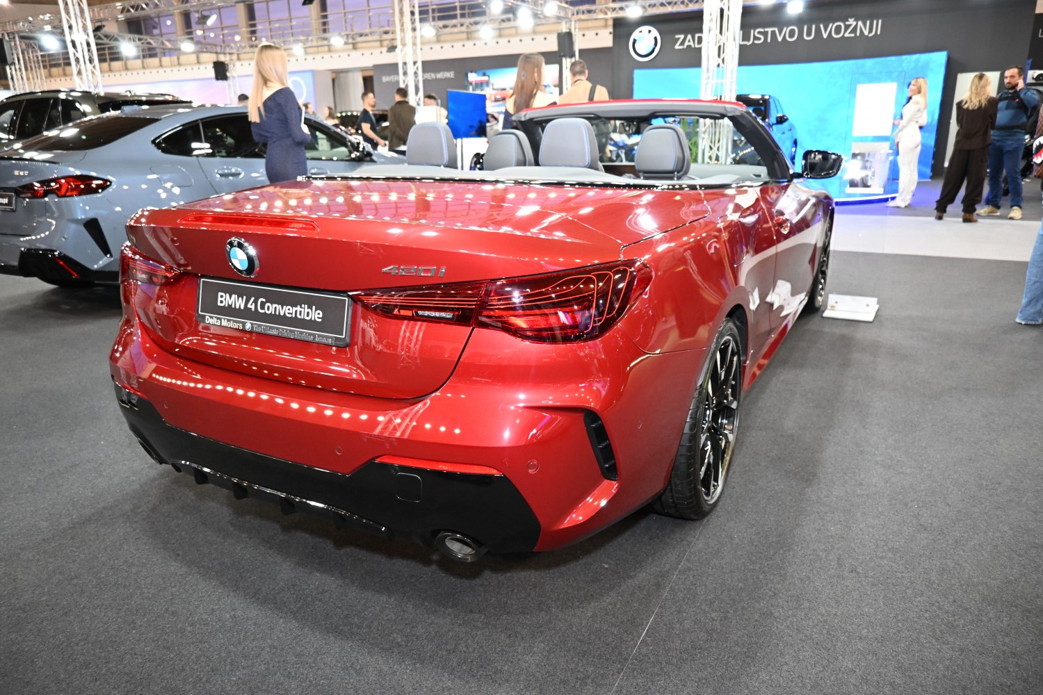 Rear view of a red convertible with LED tail lights and dual exhaust pipes