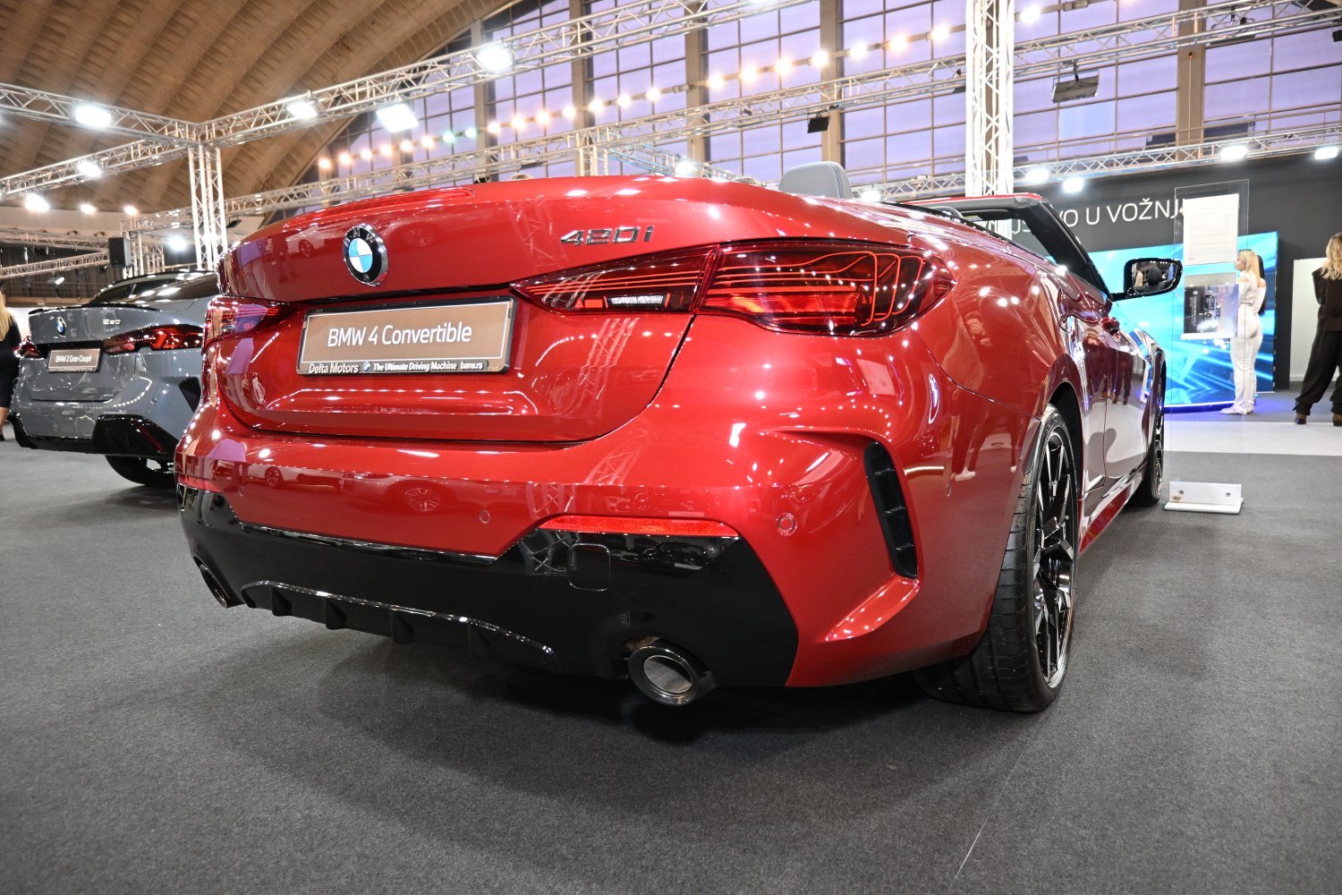 Rear view of a red luxury convertible with distinctive taillights and dual exhaust