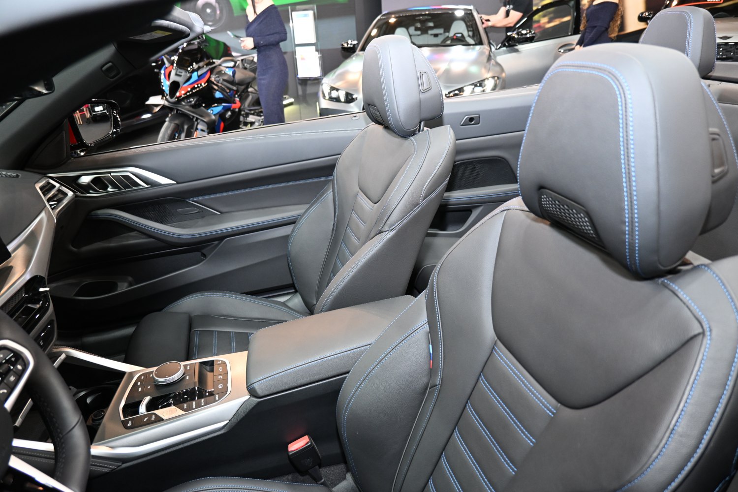 Luxury leather seats with blue stitching and modern center console