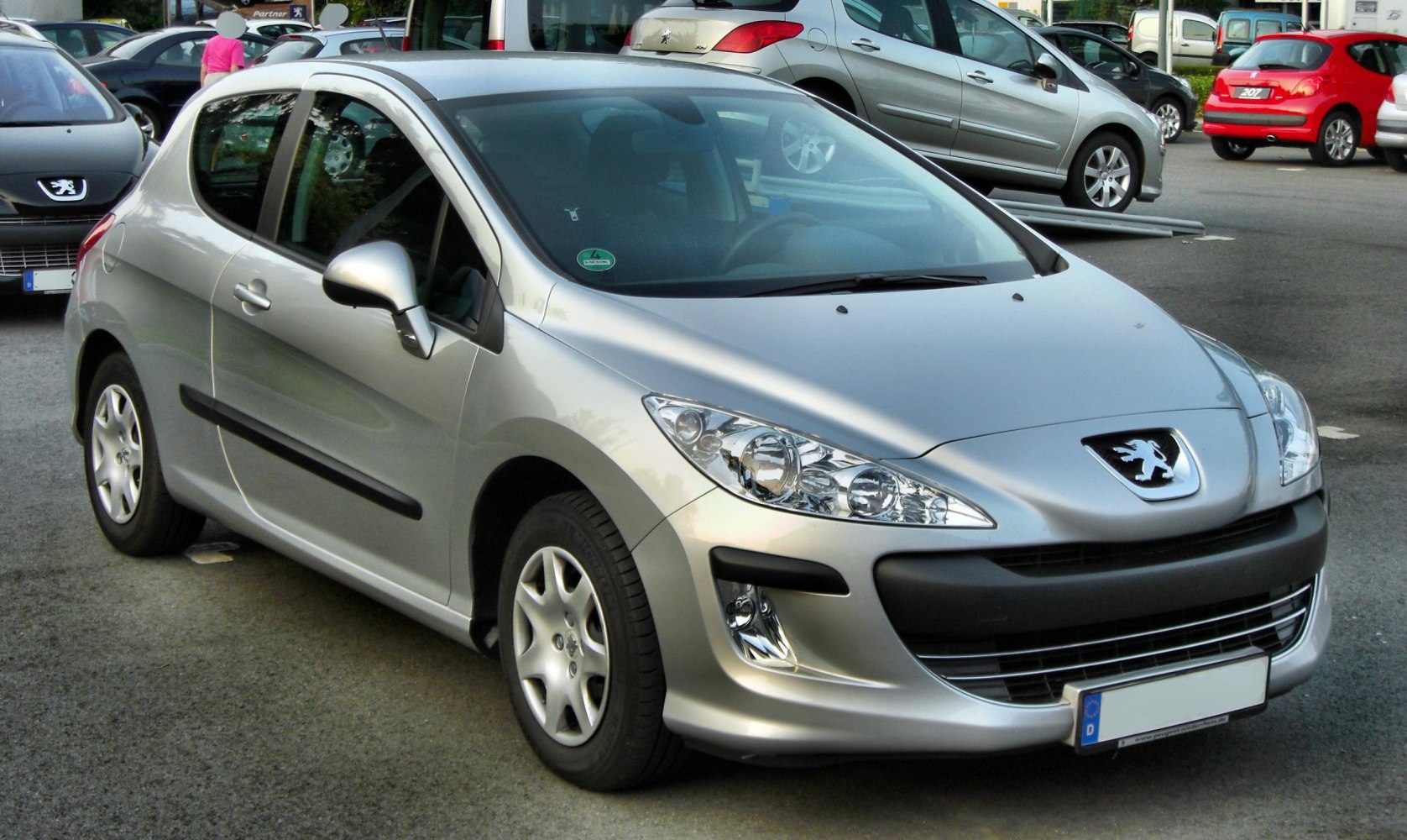 Front and side profile of a compact hatchback with distinctive headlights.