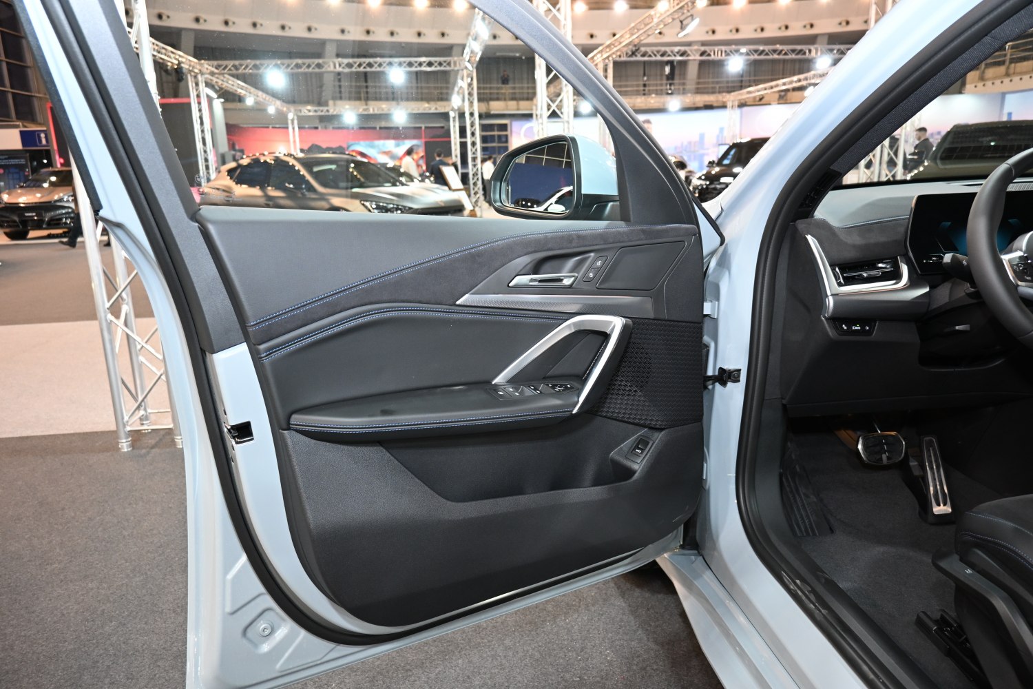 Modern interior door panel with controls and premium materials