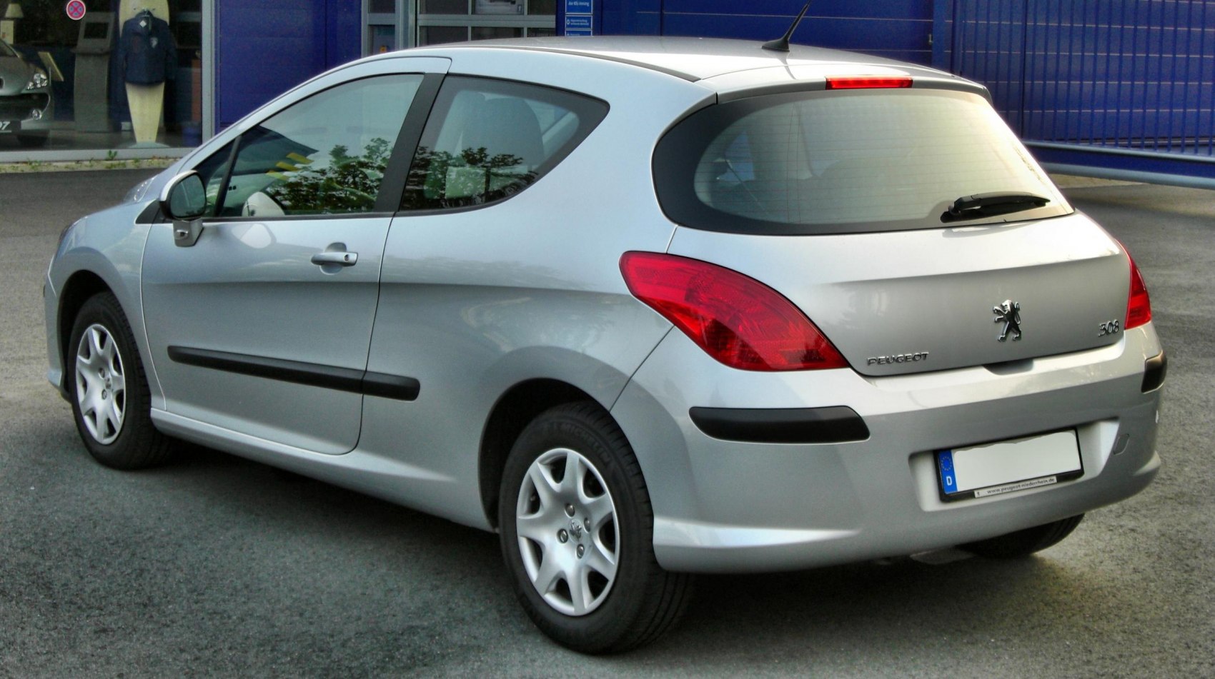 Silver hatchback rear side with distinctive tail lights
