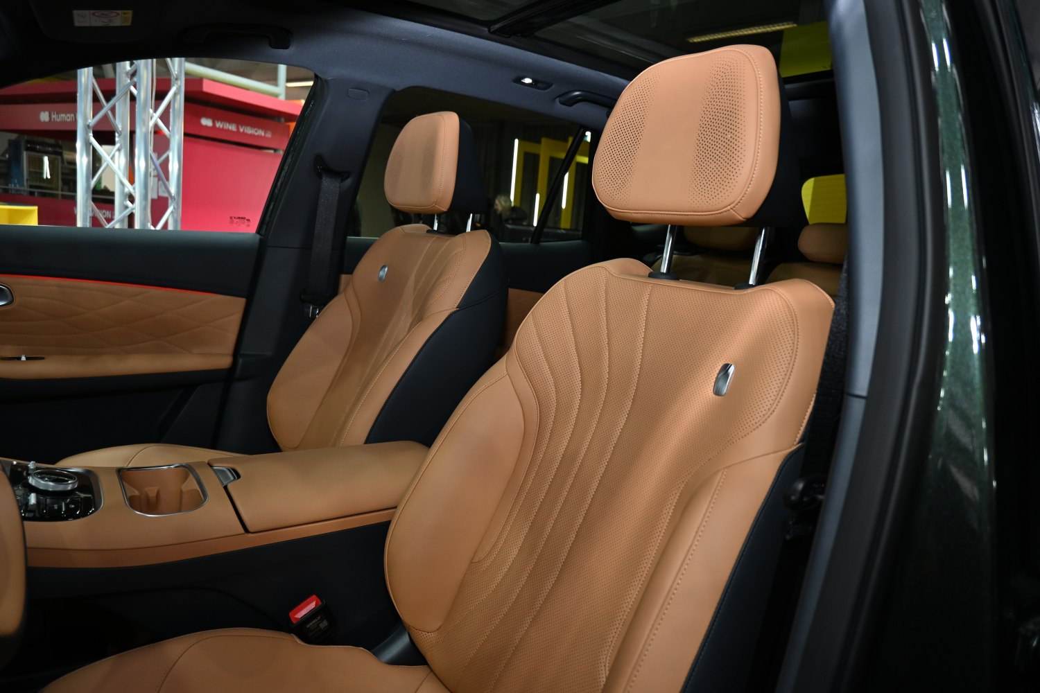 Tan leather front seats with perforation and detailed stitching.