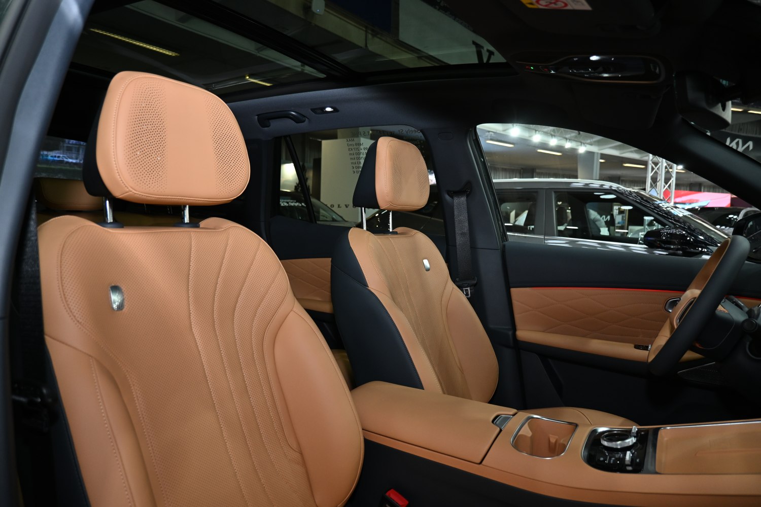 Tan leather car interior with quilted door panels and panoramic roof