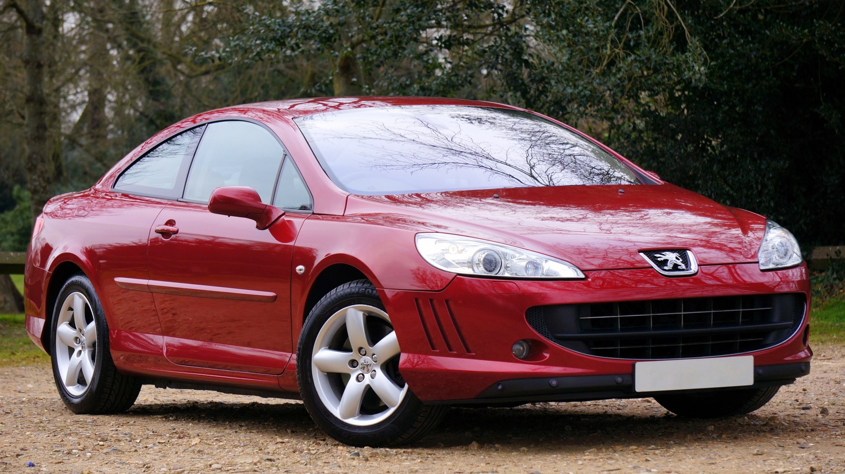 Front side view of red coupe with alloy wheels