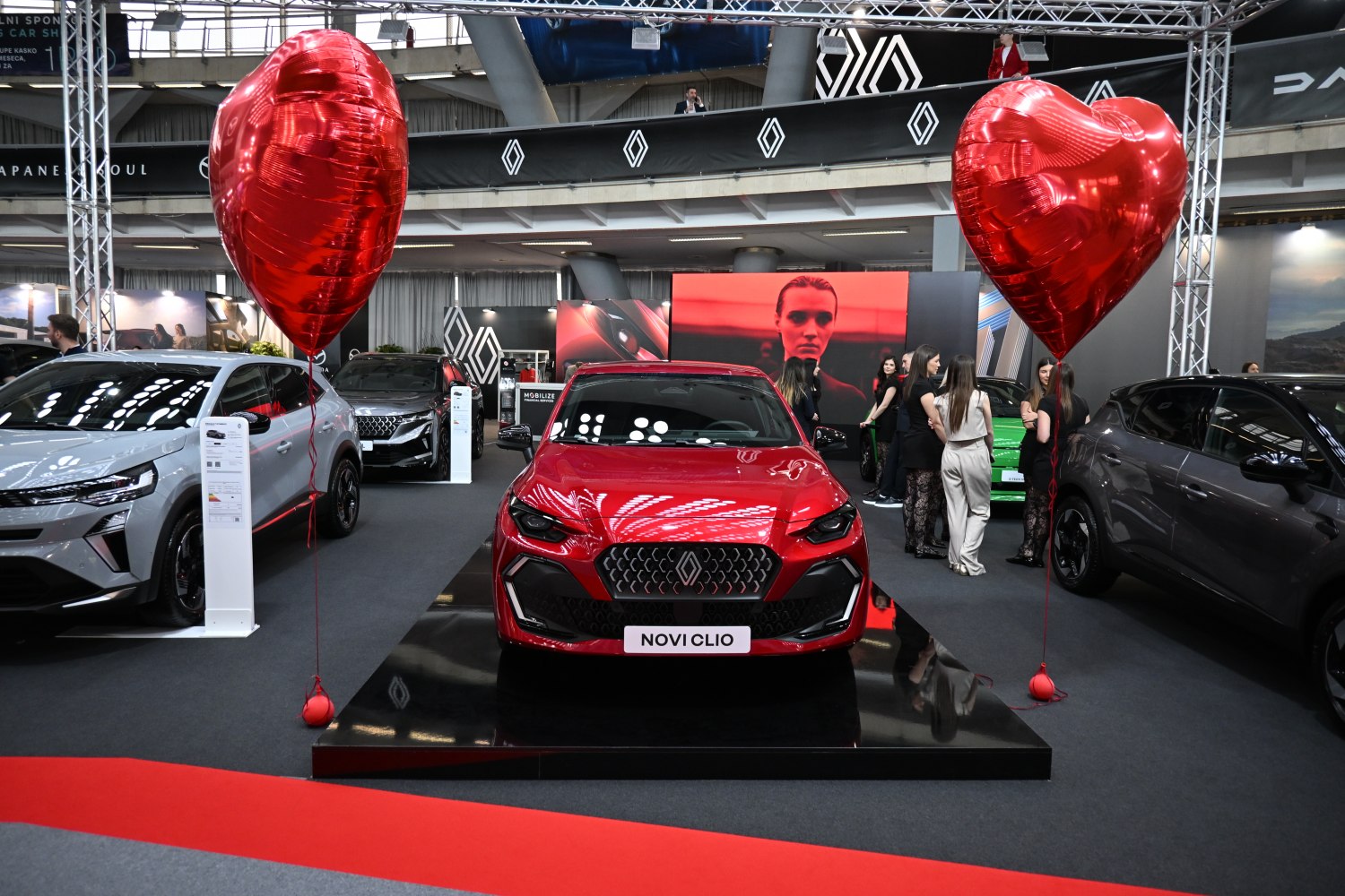 Red hatchback front view with distinct grille and headlights