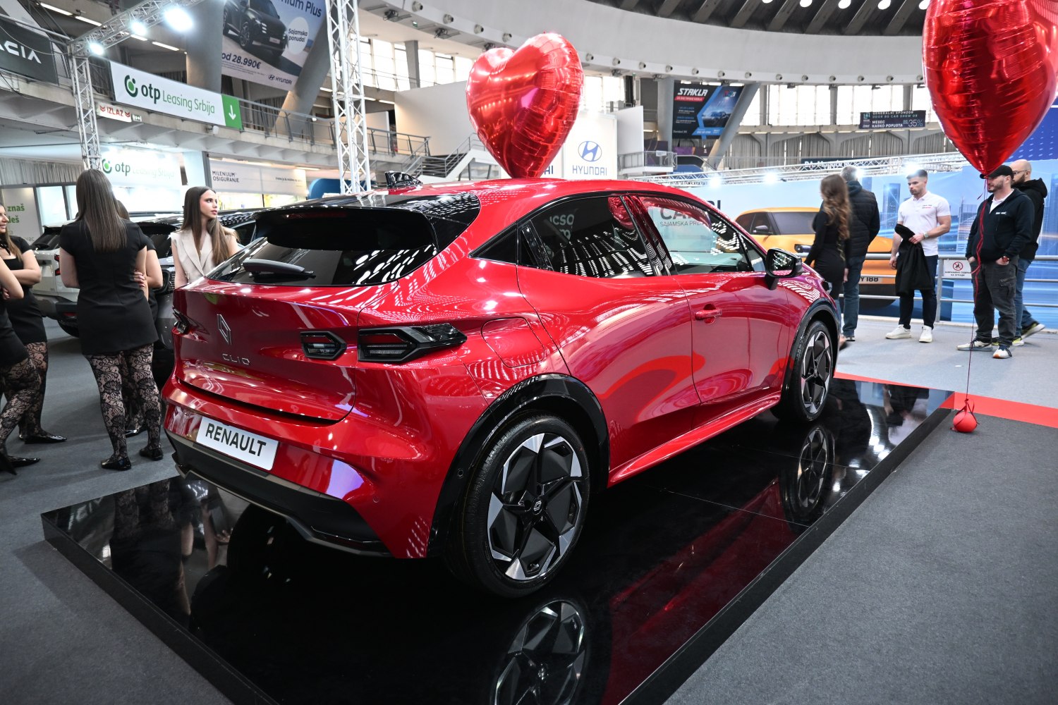 Red hatchback rear view with angular LED taillights and modern alloy wheels.