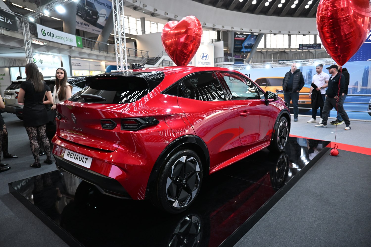 Rear and side profile of a red modern hatchback with sleek taillights