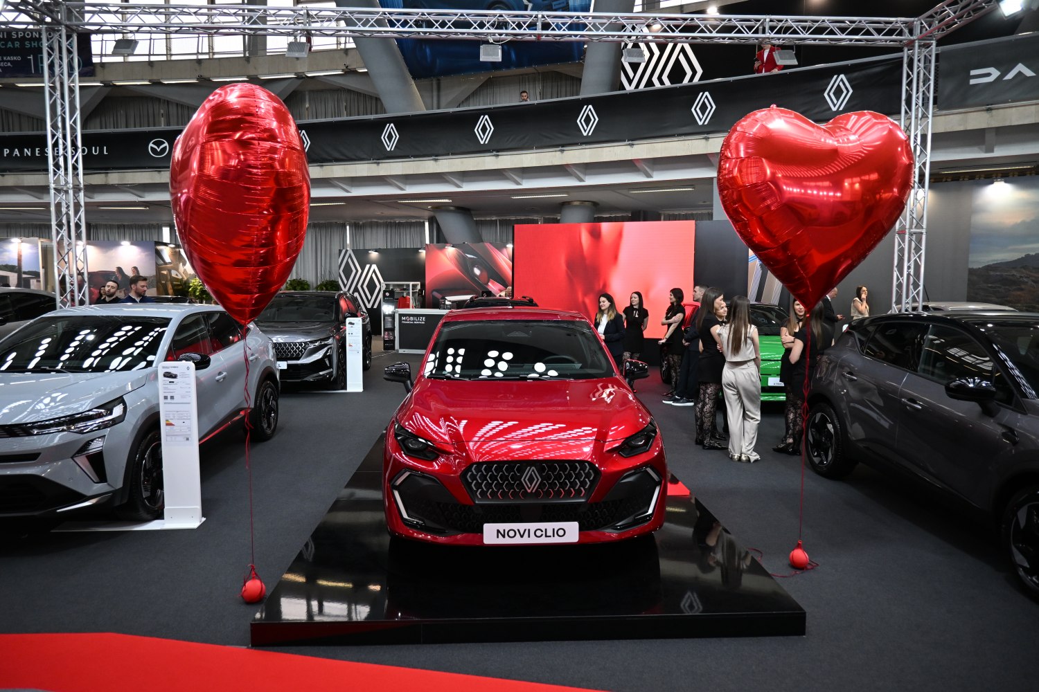 Red hatchback with distinctive front grille and modern headlights