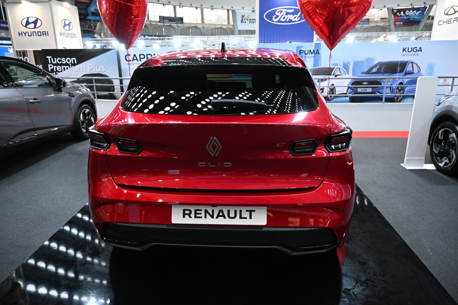 Red hatchback rear with unique tail lights and rear window wiper