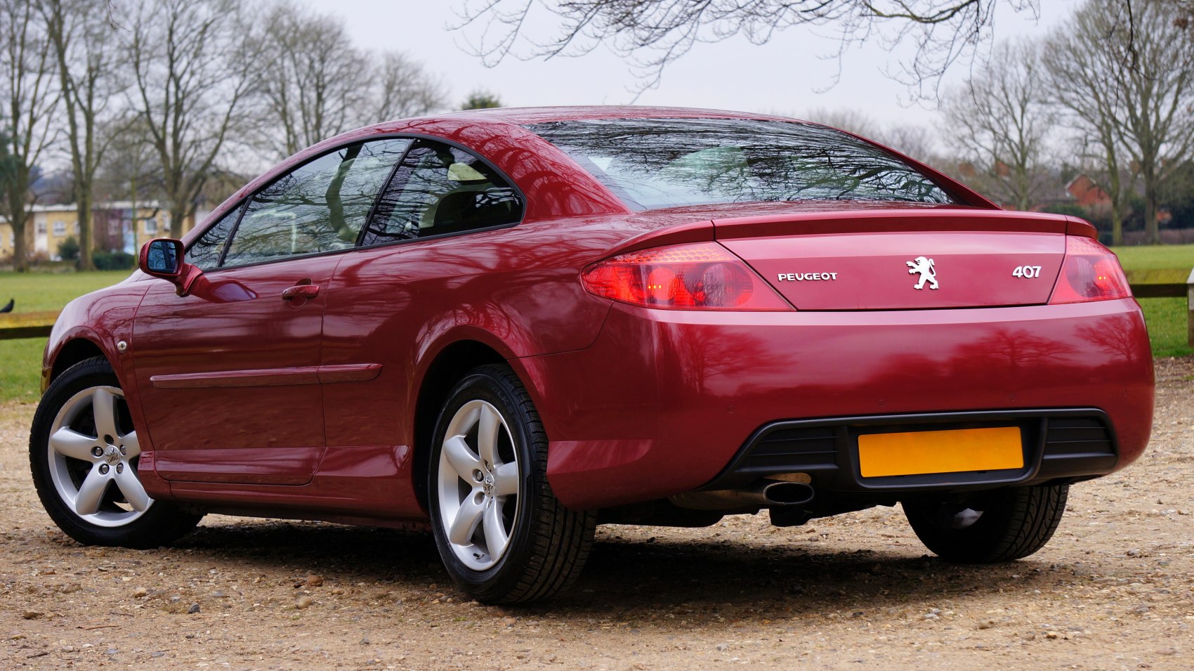 Rear-side view of a sporty coupe with sleek tail lights and alloy wheels