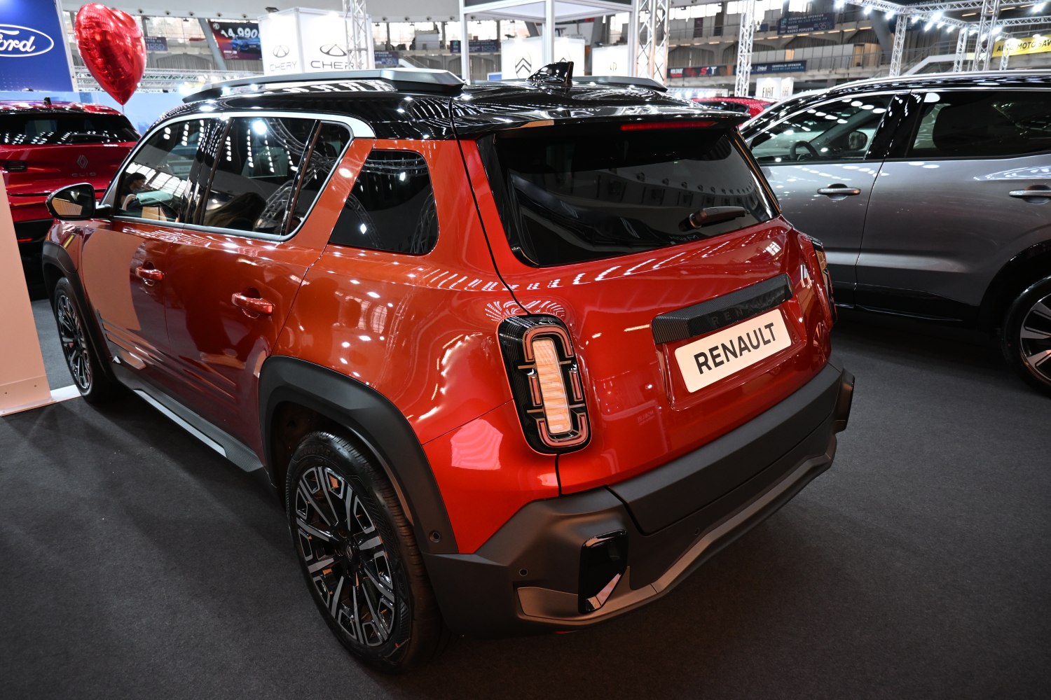 Rear and side profile of electric crossover SUV with distinctive tail lights and black alloy wheels