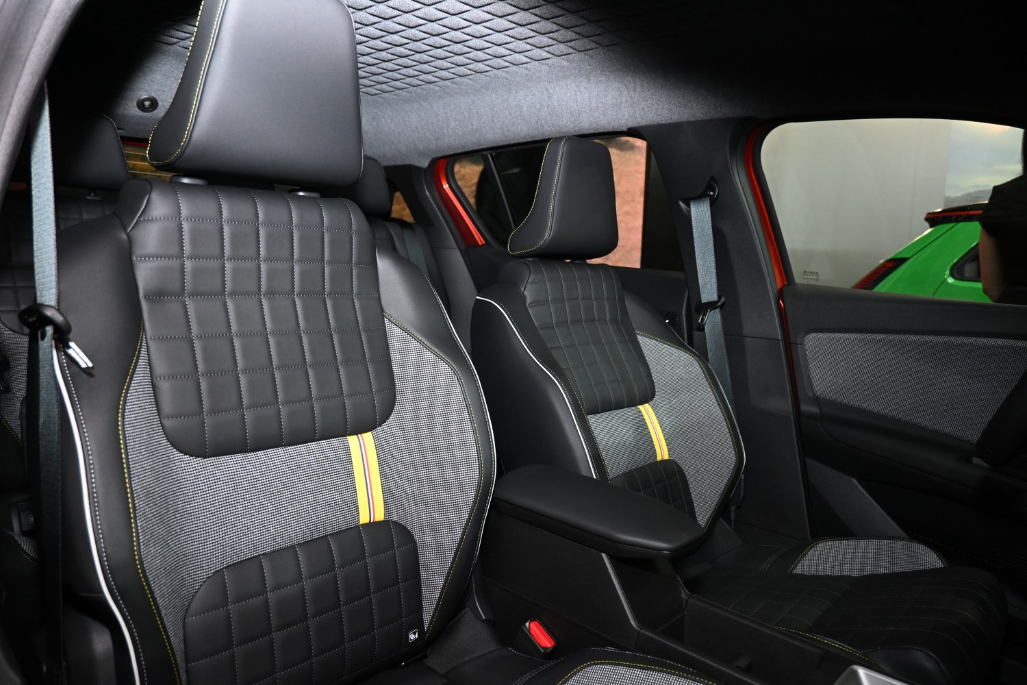 Quilted and patterned front seats with contrast stitching and armrest