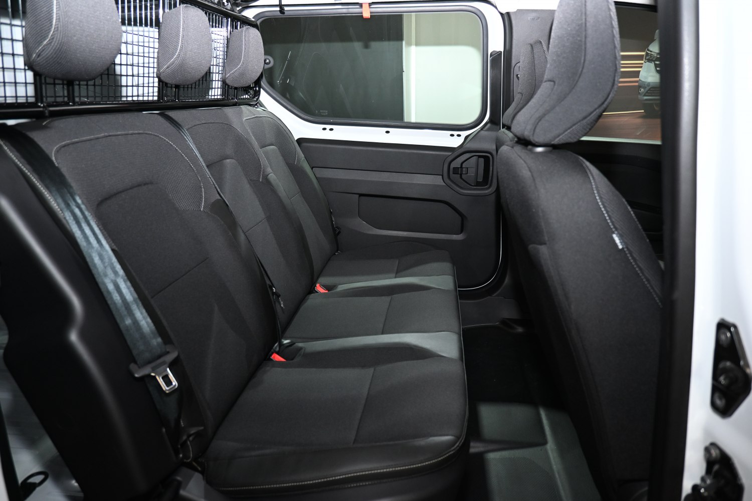 Rear passenger seat row with black fabric upholstery and headrests