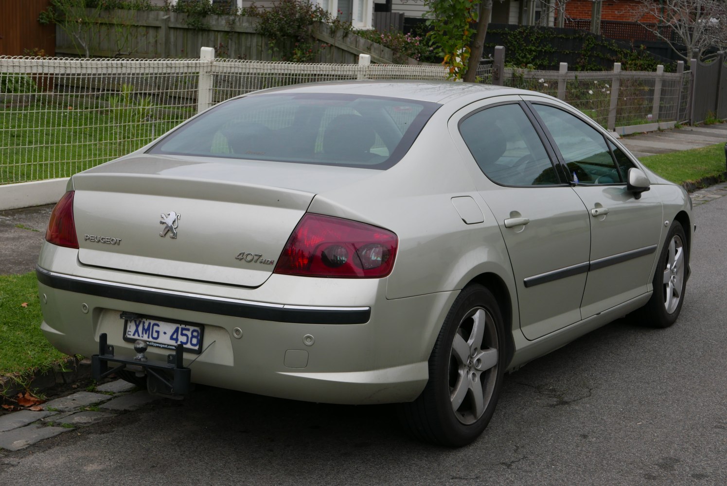 Rear view of a sedan with taillights and tow hitch