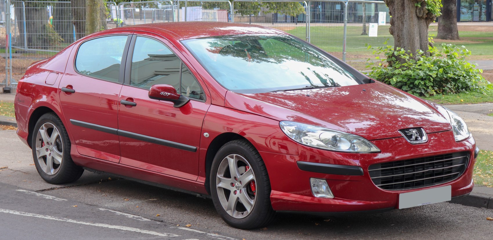 Red mid-size sedan with aerodynamic body and alloy wheels