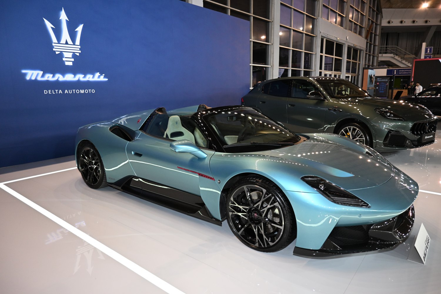 Blue luxury convertible roadster with sporty design and black wheels