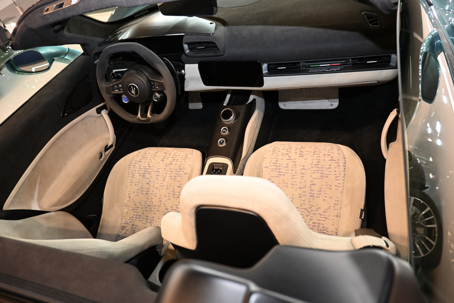 Carbon fiber steering wheel and digital dashboard with patterned luxury seats