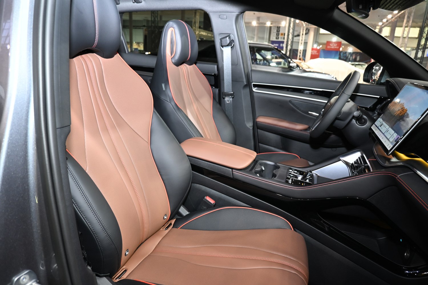 Two-tone leather seats with stitched design and modern dashboard touchscreen.