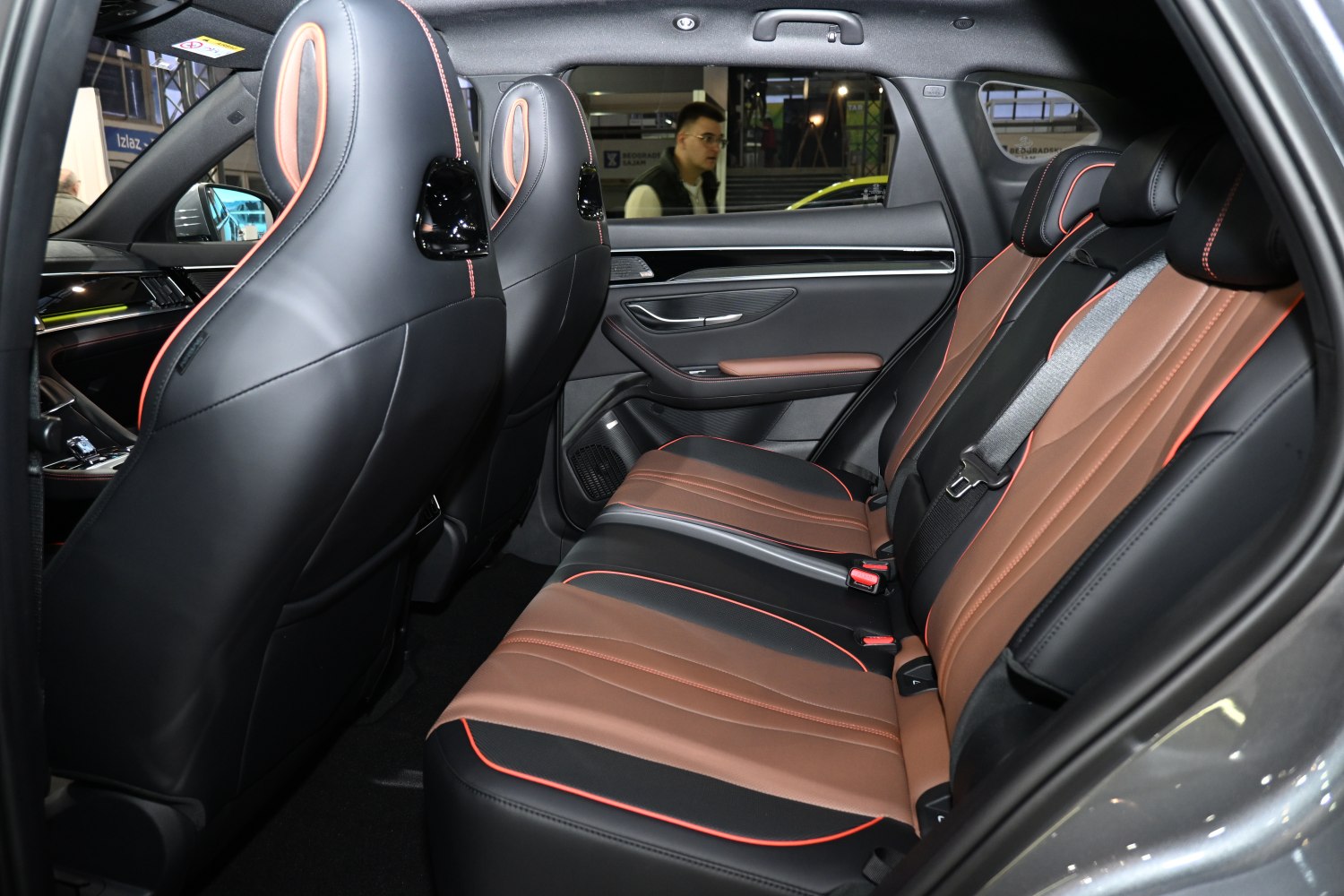 Leather rear seats with orange stitching and spacious rear passenger area.
