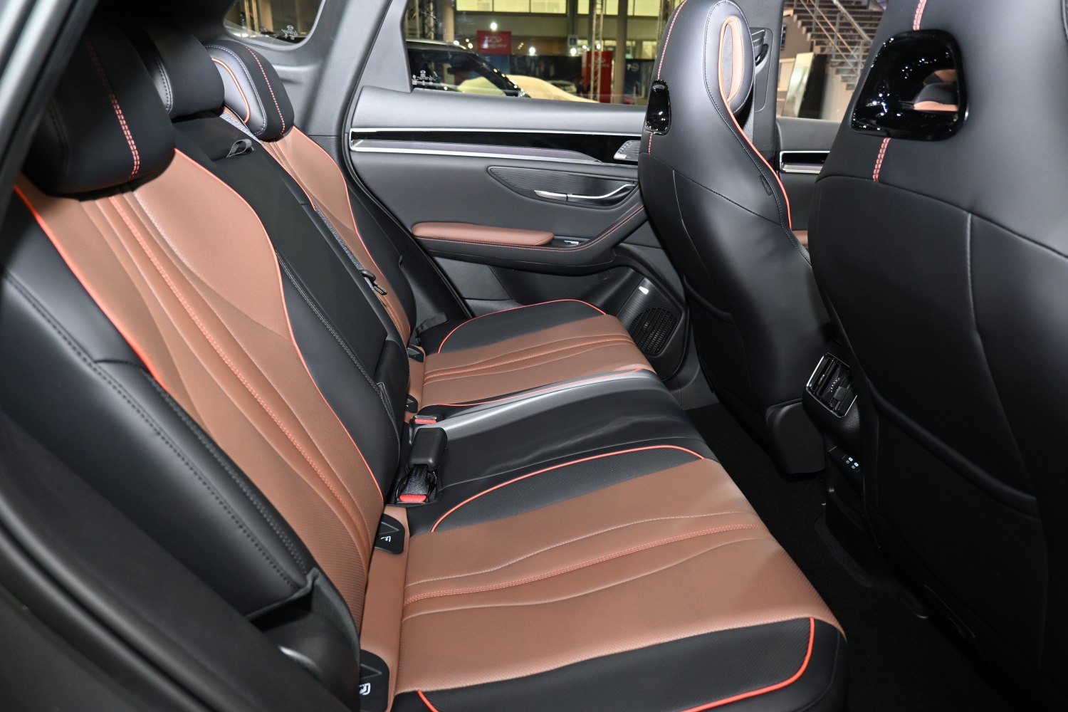 Two-tone leather rear seats with orange stitching and rear air vents