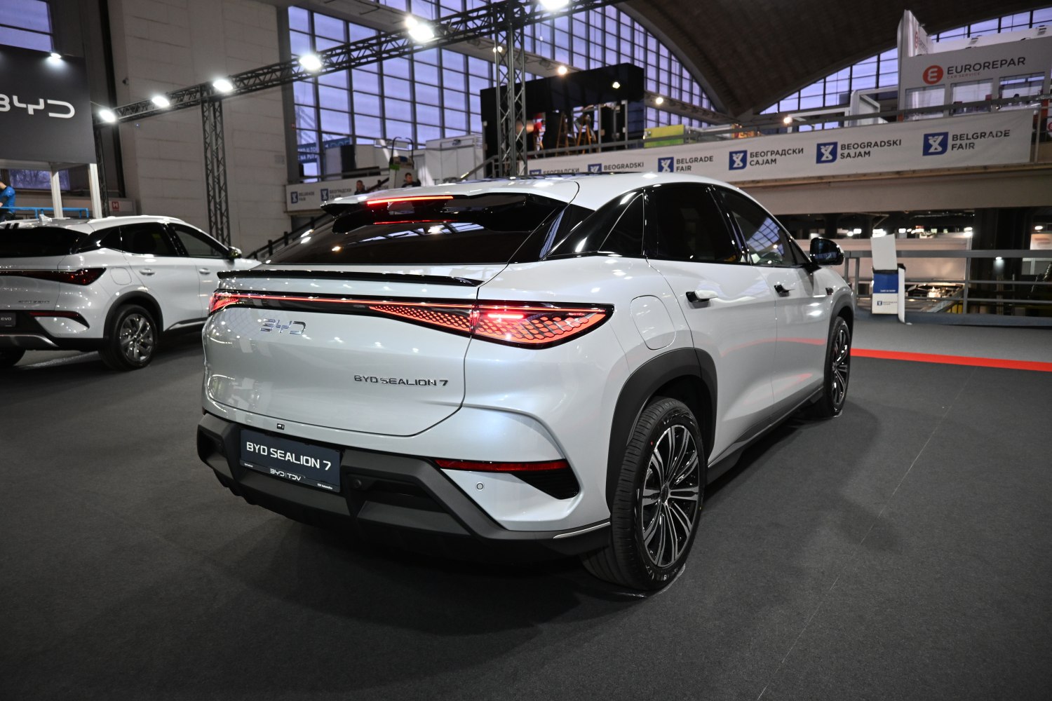 Rear view of a white SUV with LED tail lights and modern sharp design.
