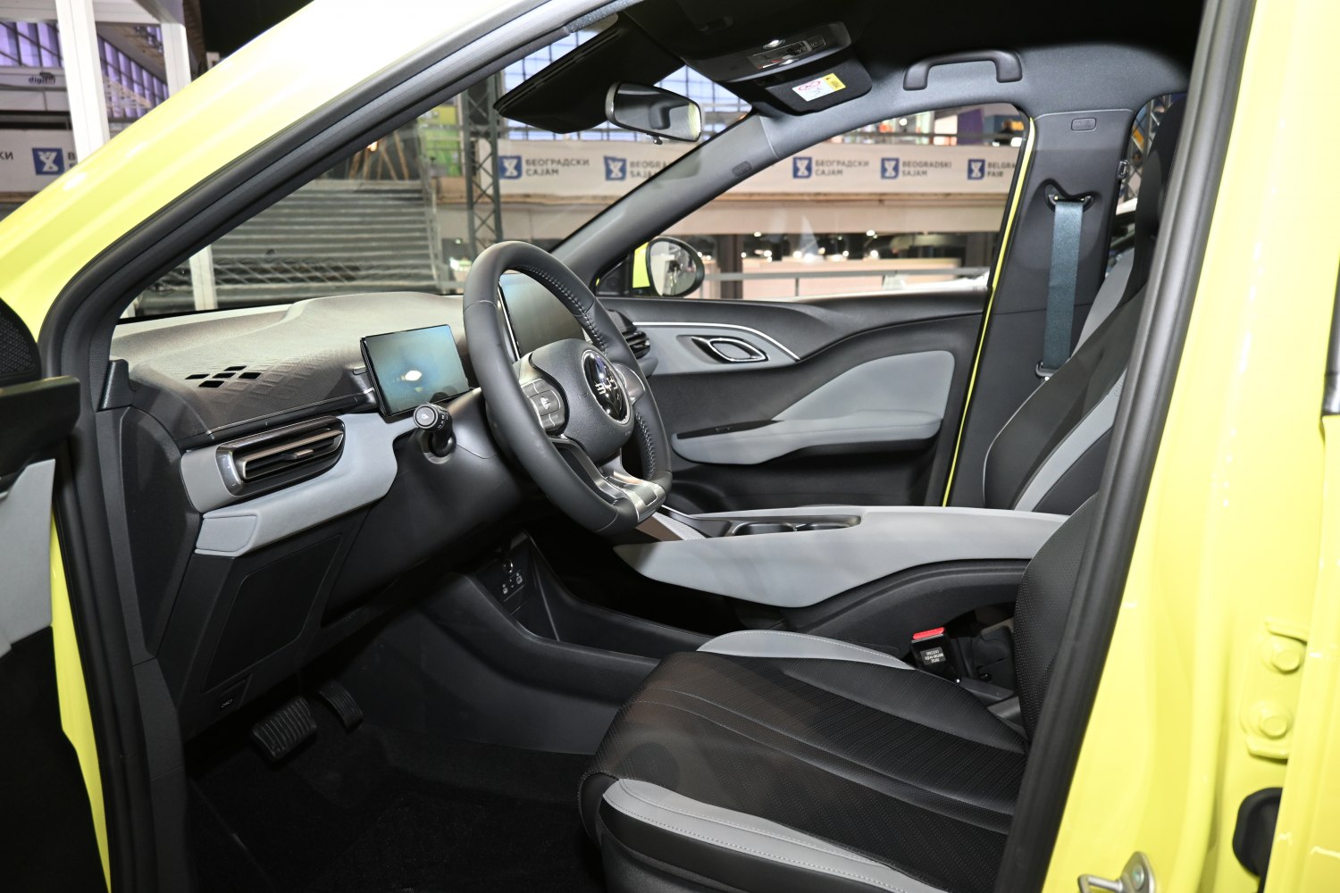 Minimalist car interior with digital displays and sleek seating
