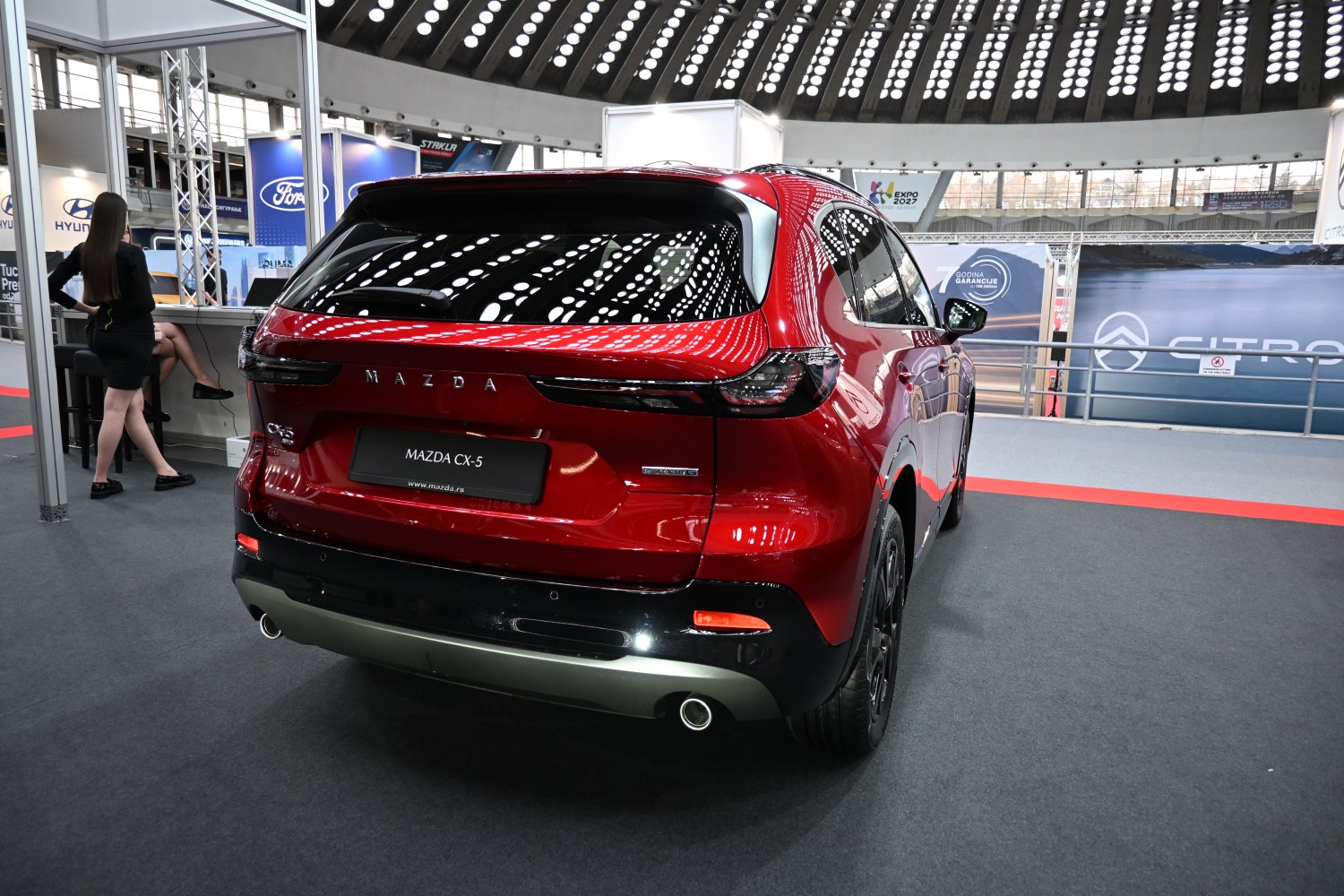Sleek rear view with distinct tail lights and dual exhaust pipes