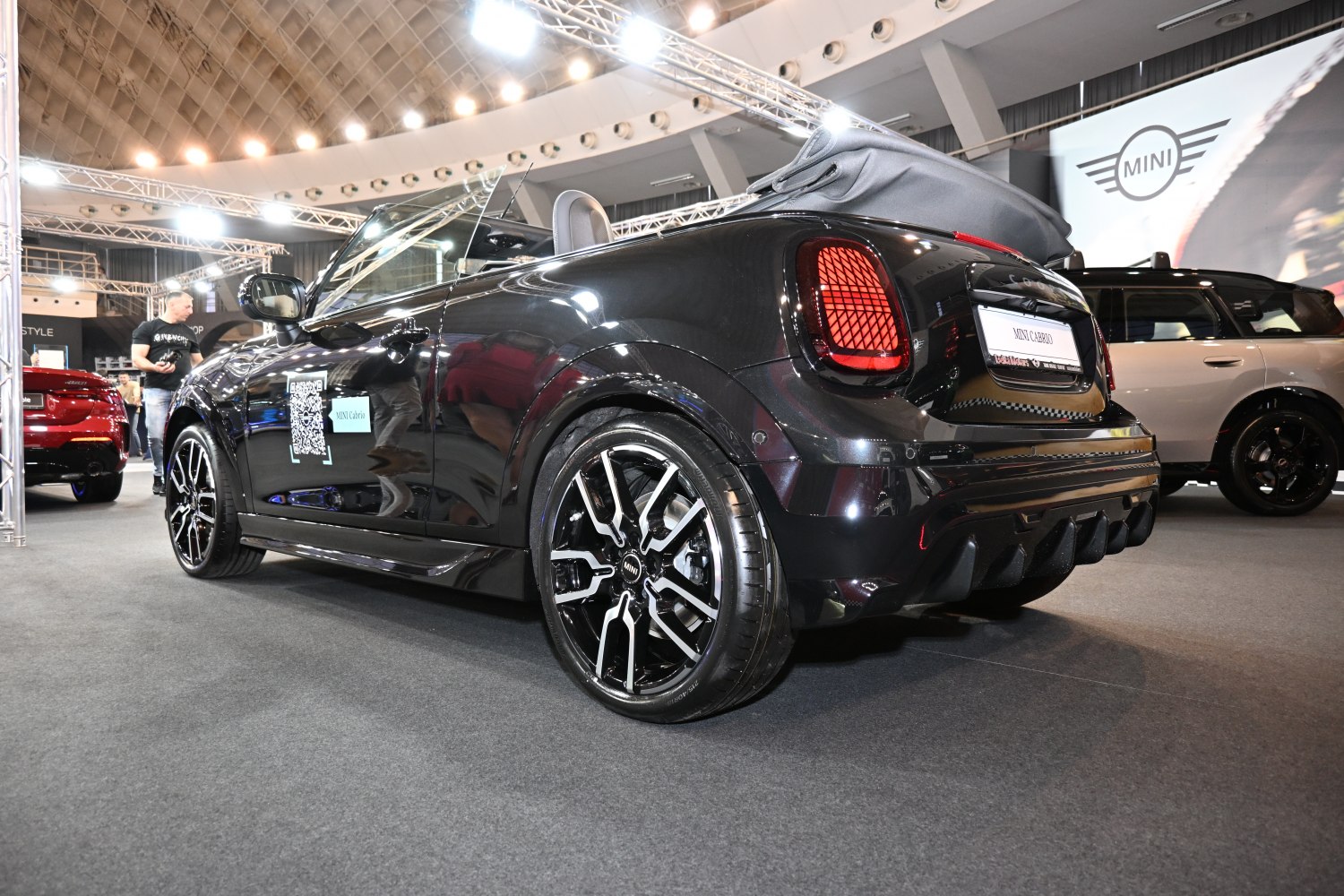 Rear view of black convertible with folded soft-top and black alloy wheels