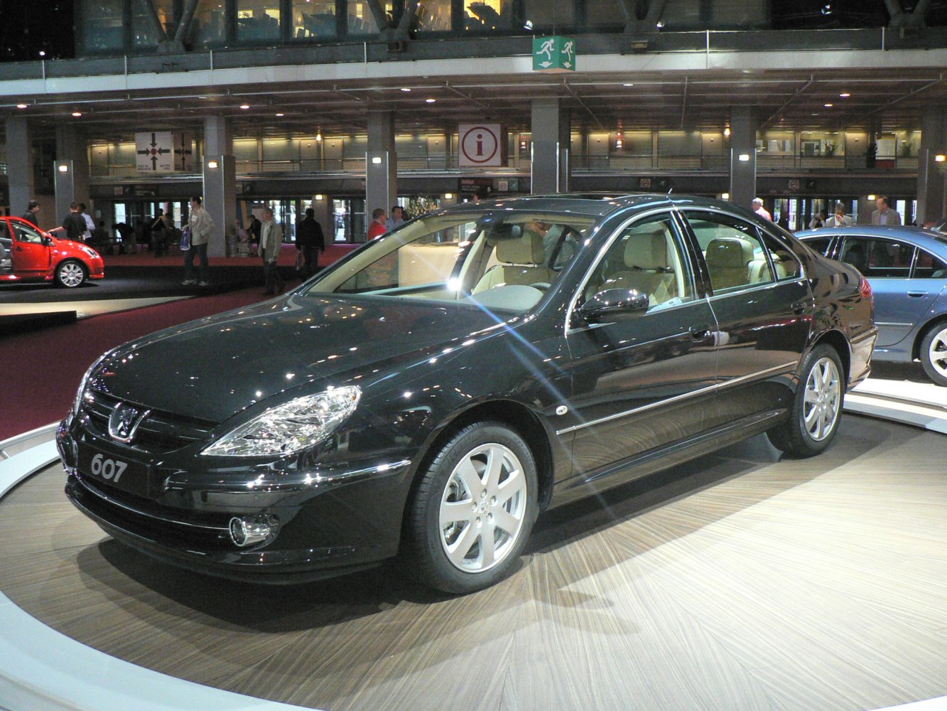 Black sedan with distinctive headlights, alloy wheels, and beige interior