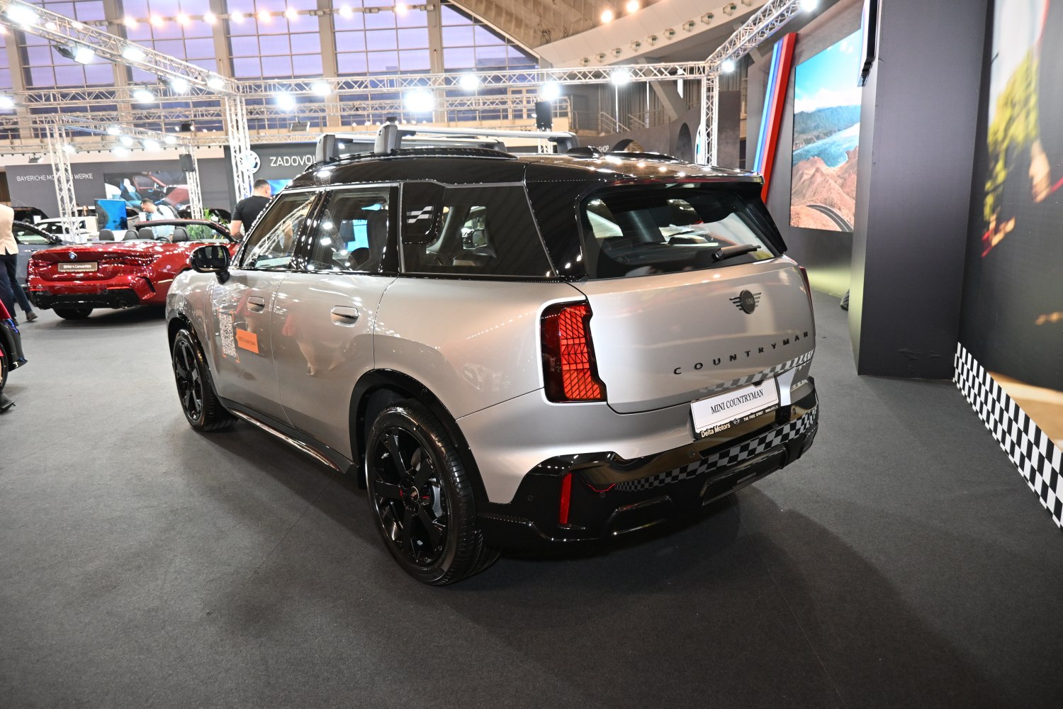 Rear-side view of a compact SUV with roof rails and unique tail lights
