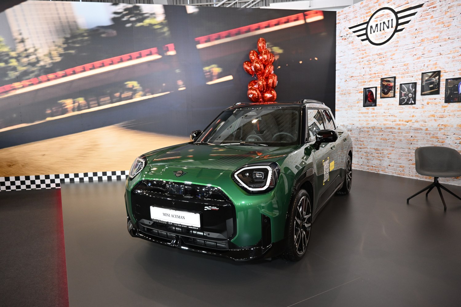 Green vehicle with angular headlights and bold front grille.
