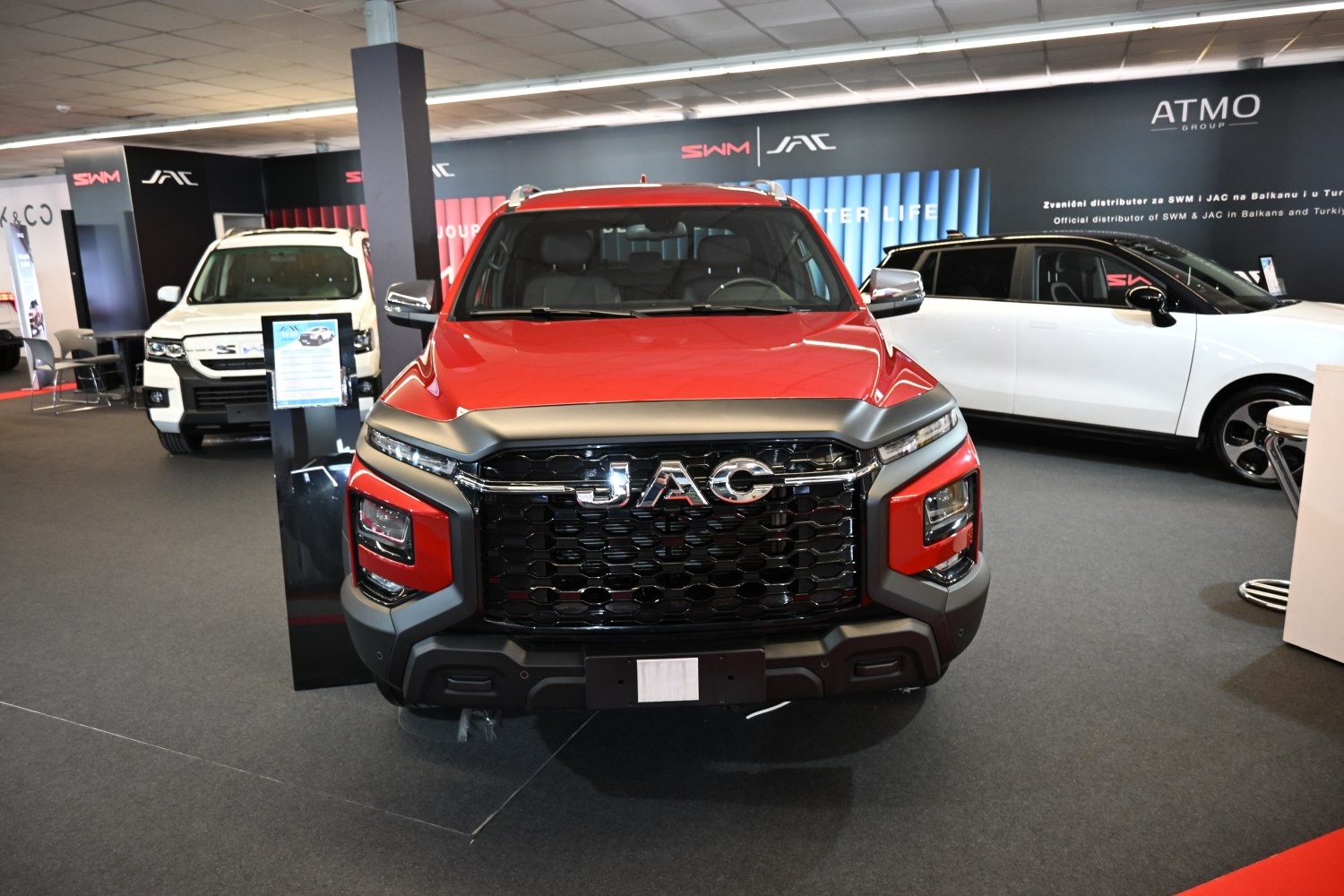 Bold front grille and LED headlights of a pickup truck in showroom.