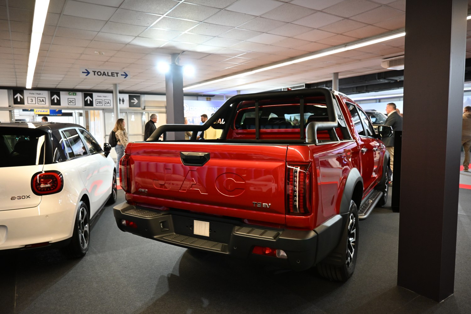 Red double cab pickup tailgate with roll bar and modern tail lights