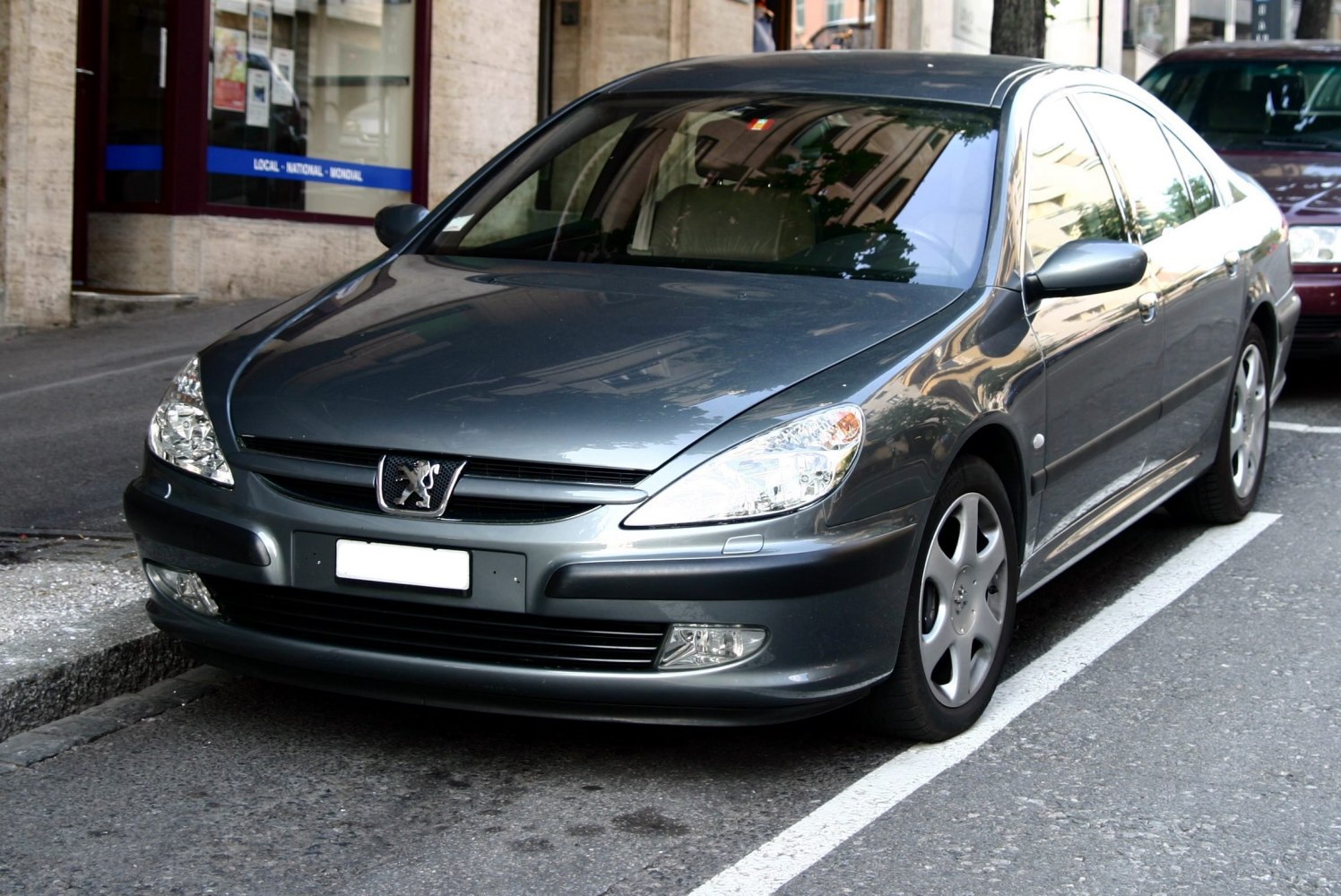 Front sedan view with sleek headlights and alloy wheels