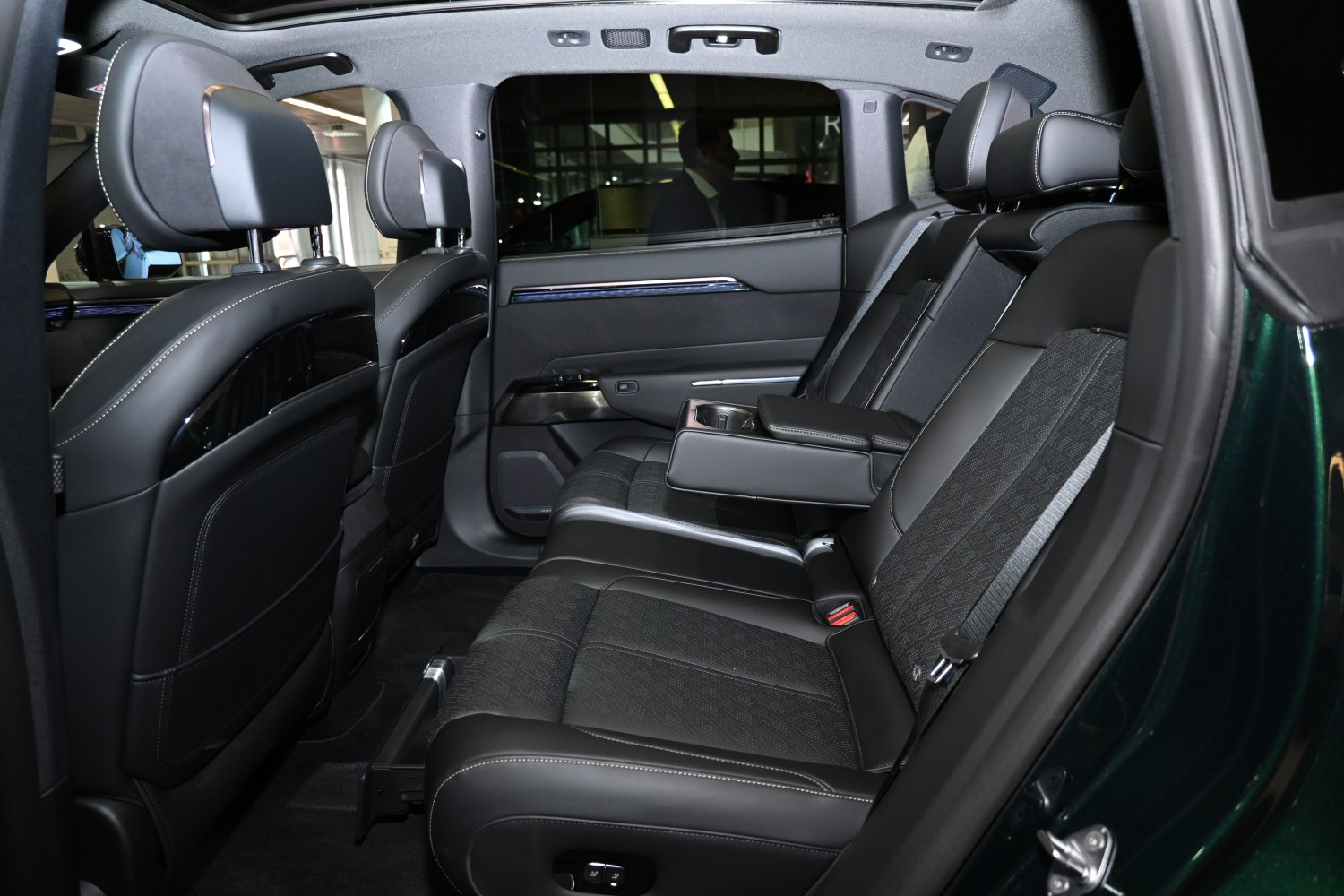 Rear seating with black leather upholstery and foldable armrest