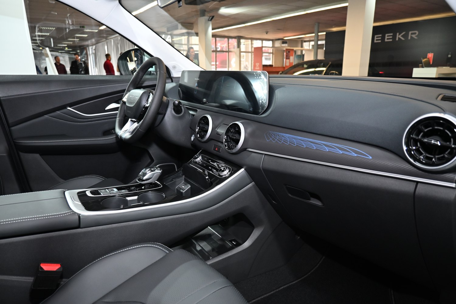 Modern car interior with digital dashboard and circular air vents
