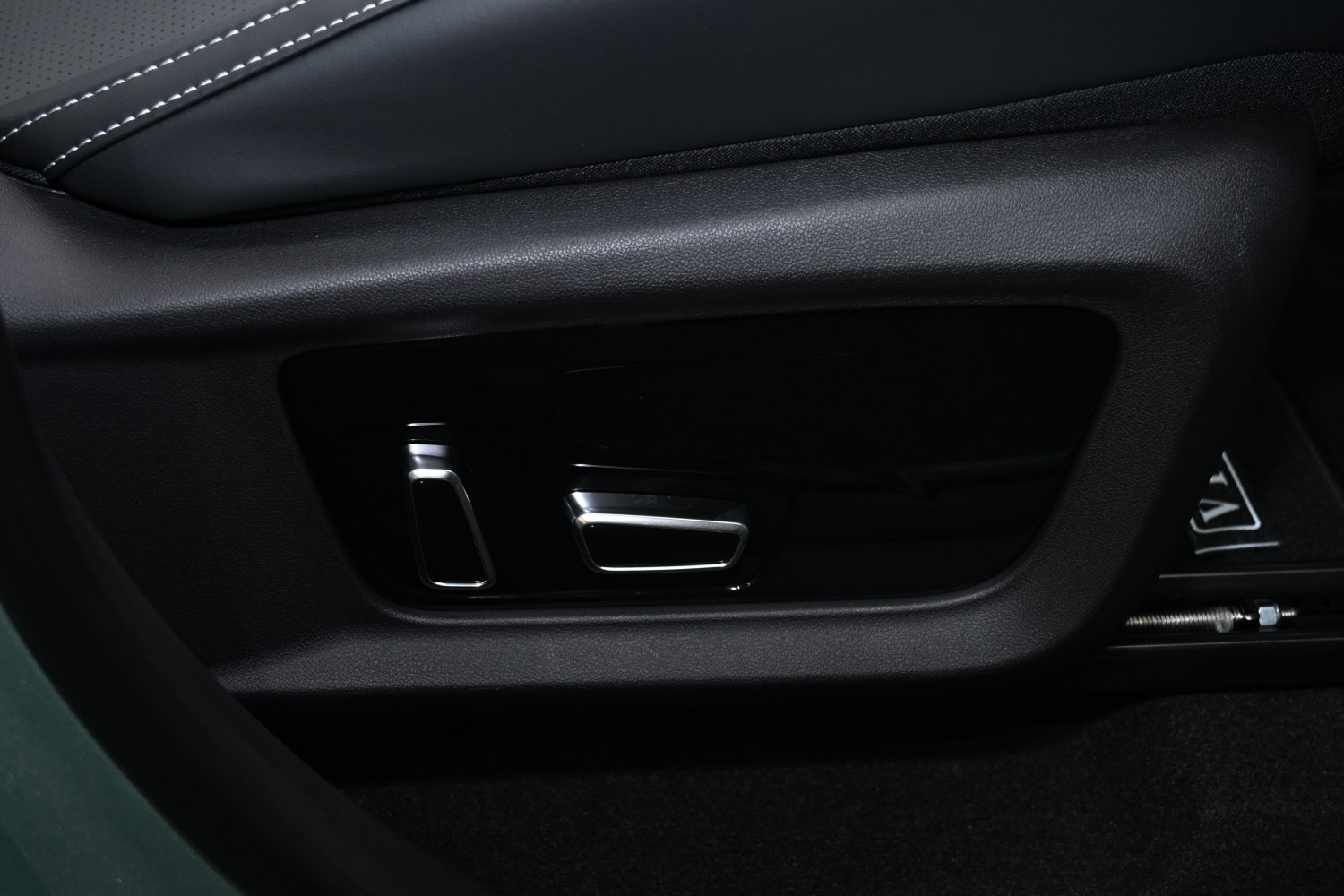 Close-up of power seat adjustment controls on car interior