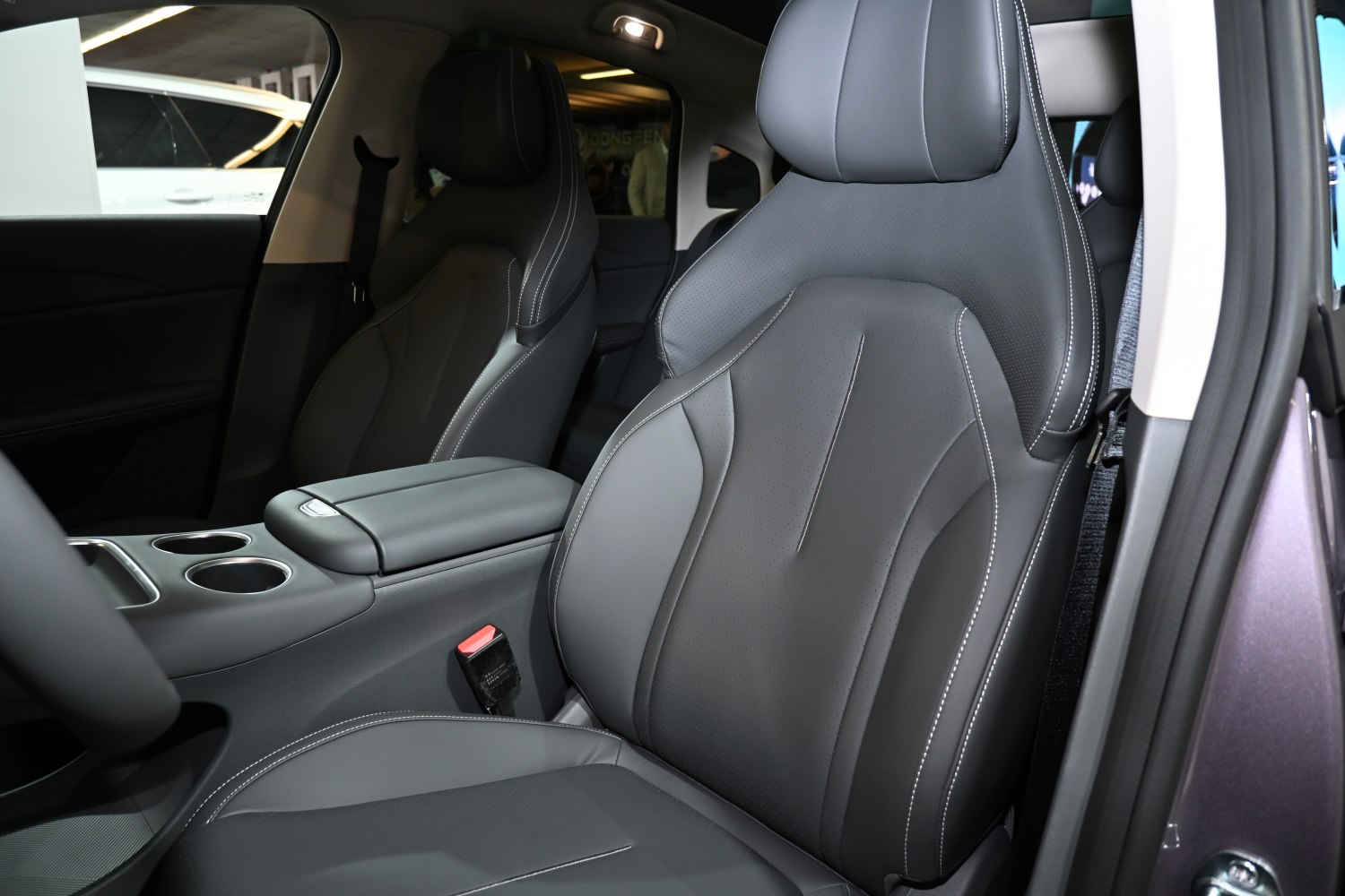 Premium leather front seats with detailed stitching and center console.